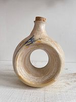 Front view of ring jug showing circular form, glaze, and cork