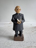 front view of carved wood priest figurine
