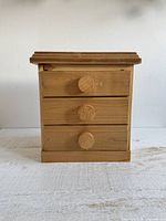 Front view of wooden 3-drawer chest