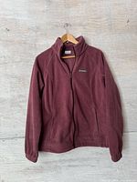 Front view of burgundy Columbia fleece jacket on hanger