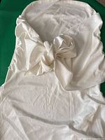 Chair cover laid flat showing bow detail