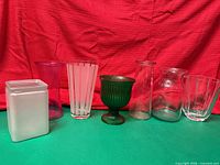 Front view of all seven glass vases and containers