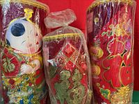 Front view of three wrapped decorative pillars showing motifs and colors