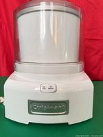 Front view of Cuisinart ice cream maker showing base, freezer bowl, lid and power switch