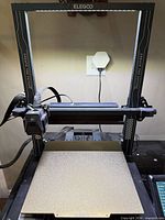 Front view of Elegoo Neptune 4 Plus printer with build plate and gantry