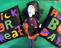 Both pillows and witch doll displayed together