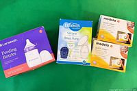 Front view of all four boxed items on green background