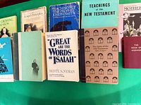 Books laid out showing eight identifiable titles and two obscured spines