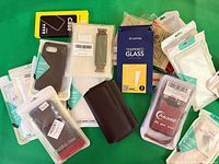 Overview of all packaged cases and protectors spread on green background