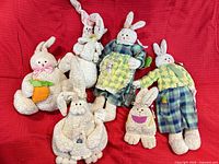 All six plush bunnies on red background, showing overall lot