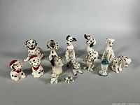 Front view of all 14 Dalmatian figurines arranged in rows