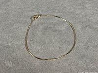 Full view of 14K gold bracelet laid flat