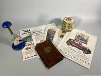 Overall view of hat stand, advertisements, journal cover, hair pins box