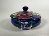 Front view showing lid decoration and body