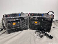 Front view of two Sony TC-142 recorders and microphone