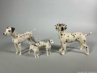 All four Dalmatian figurines lined up largest to smallest