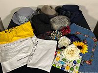 Overall view of five hats, dust bags and accessories