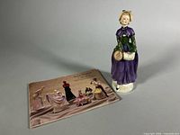 Figurine standing beside collectors booklet