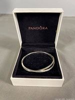 Bangle resting inside Pandora branded box
