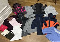 All 14 garments spread out flat on floor