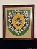 Full view of needlepoint artwork in frame