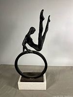 Front view of cast metal gymnast sculpture on marble base