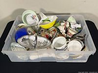 Overview of bin filled with assorted chinaware pieces