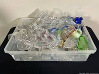 Bin filled with assorted glassware and crystal pieces