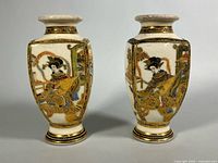 Front view of both Satsuma vases showing court lady scenes and gilt decoration