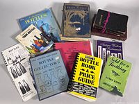 Group shot of all eleven books and booklets arranged on flat surface