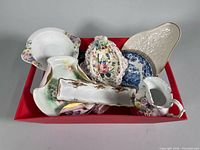 Mixed china pieces in red bin showing overall lot