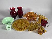 Overall view of all nine glass pieces in lot