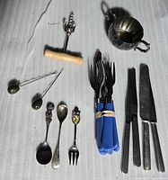 All utensils, sugar bowl, corkscrew grouped on surface