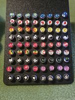 Full view of display card showing rows of assorted novelty stud earrings