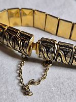 Close-up of box clasp, safety chain and adjacent links showing leaf motif