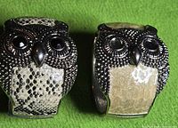 Front view of both owl bracelets showing rhinestone faces and snakeskin panels