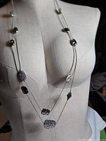 Necklace displayed on mannequin showing twin strands and station accents