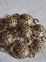 Front view of brooch showing seven domed floral motifs