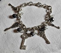 Full view of bracelet showing chain links, charms, and beads