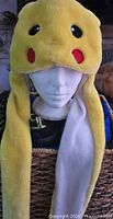 Frontal view of Pikachu hat on mannequin showing long scarf flaps