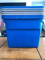 blue plastic bin with stacked matching lids