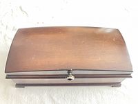 Closed Bombay & Co. mahogany jewelry music box showing exterior finish and knob