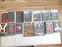 All 13 books laid out in two rows