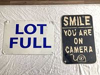 Both steel signs side by side on surface