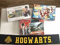 Group view of three board games and Hogwarts scarf