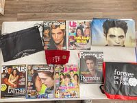 Entire lot overview showing magazines, bags, beanie, pillowcase