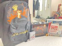 Group shot showing backpack, lunchbox, travel mug box, tin and accessory