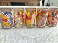 Front view of five Pooh themed glasses displayed side by side