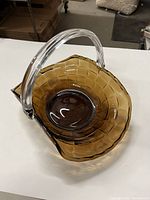 Top angle of amber basket showing clear handle and interior