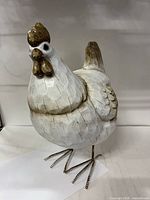 Front view of white chicken figurine